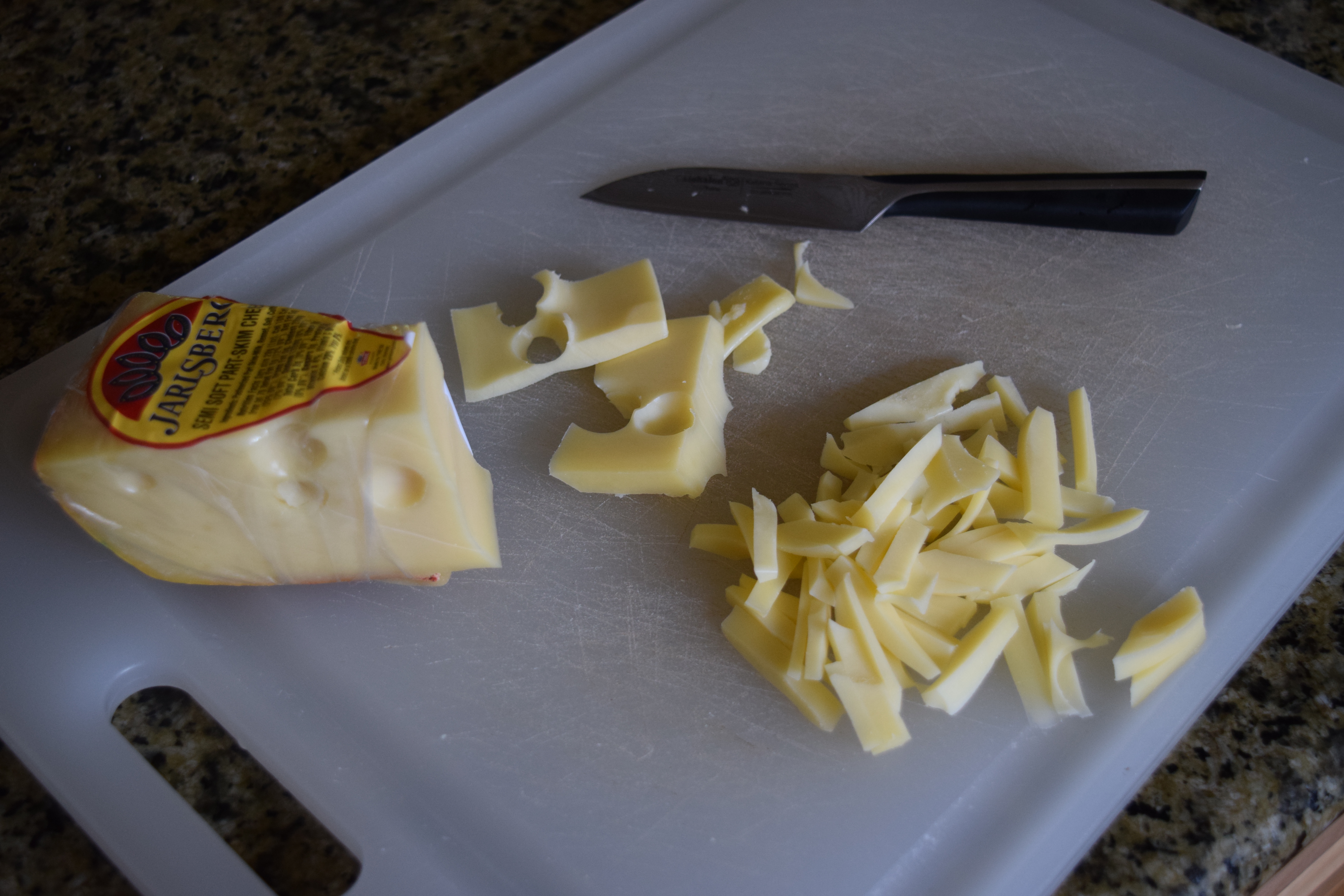 Jarlsberg cheese cut up