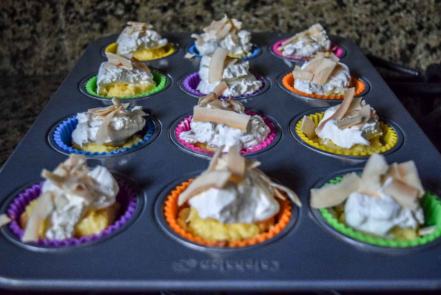 Finished Coconut Cream Pie Bites topped with toasted coconut flakes in tray
