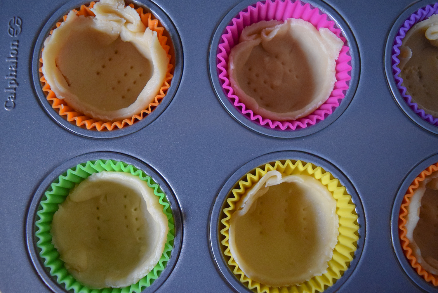 Pie crust in silicone baking cups before baking