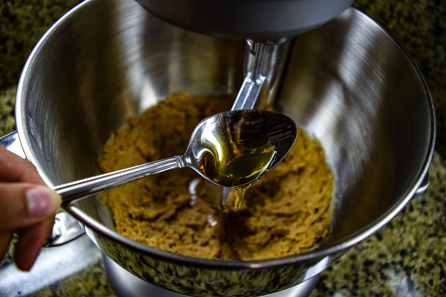 Adding the maple syrup to the KitchenAid Mixer bowl
