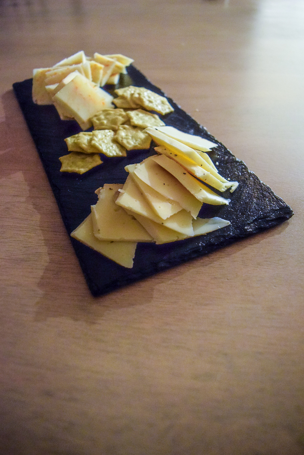 Front view of Gluten-Free Peppery Slate Cheeseboard with Trader Joe's Gluten-Free Savory Thin Mini Edamame Crackers