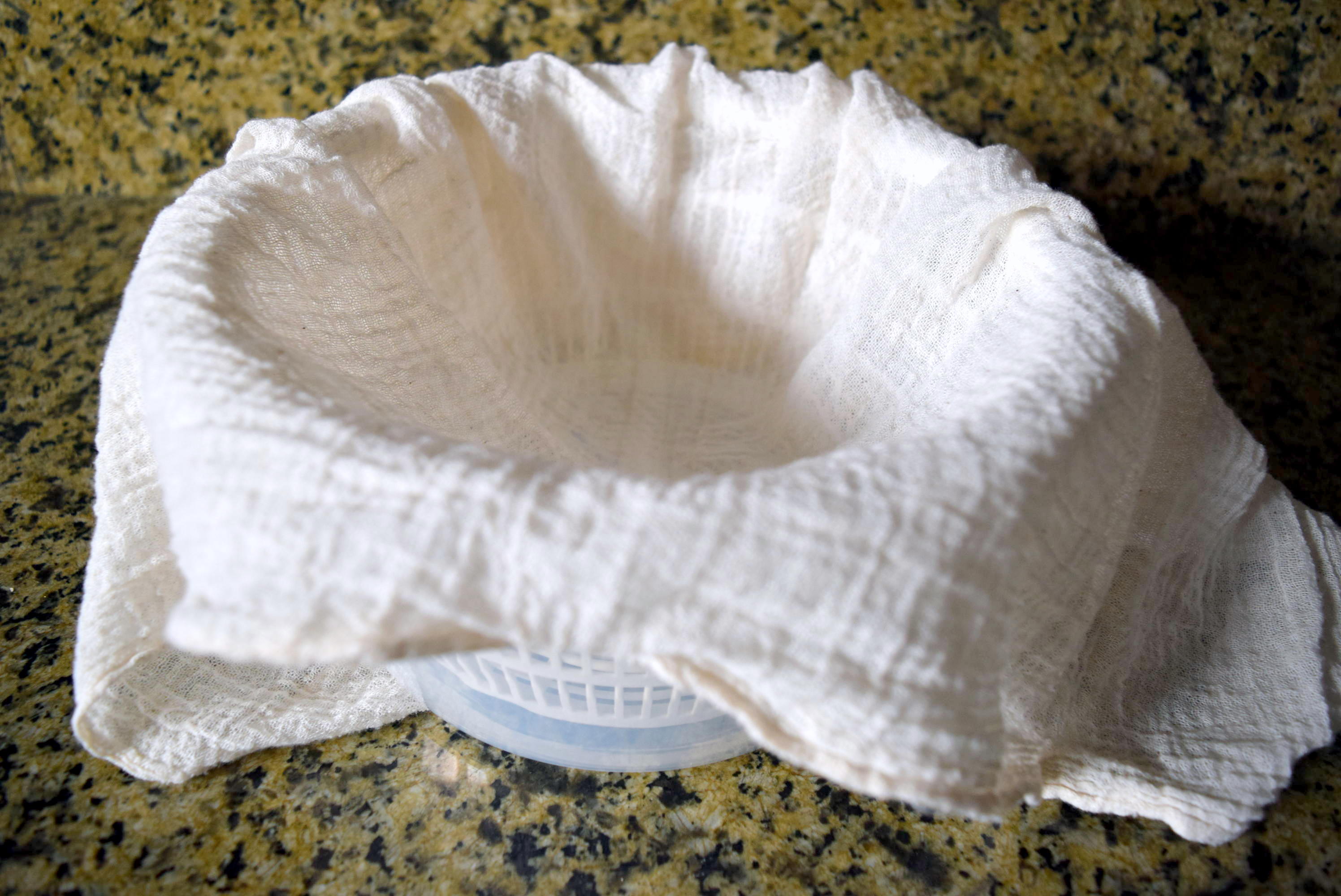 Cheesecloth and IKEA Tokig salad spinner for Homemade Instant Pot Ricotta Cheese from top angle