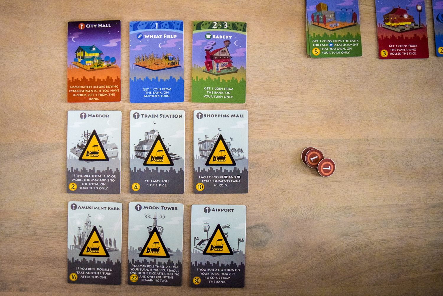 Initial personal city cards while playing Machi Koro: Bright Lights, Big City from top