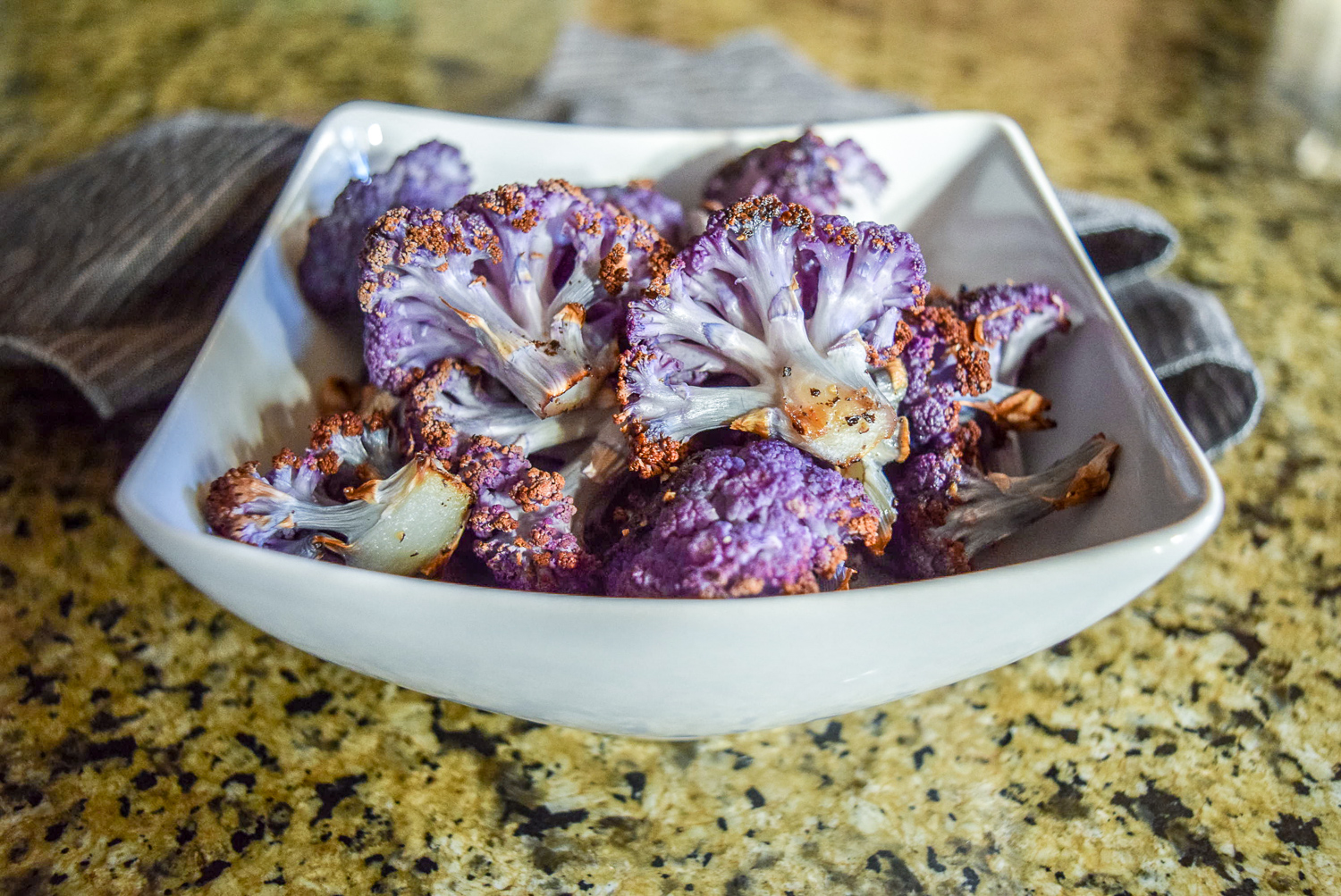 Finished roasted purple cauliflower florets from front