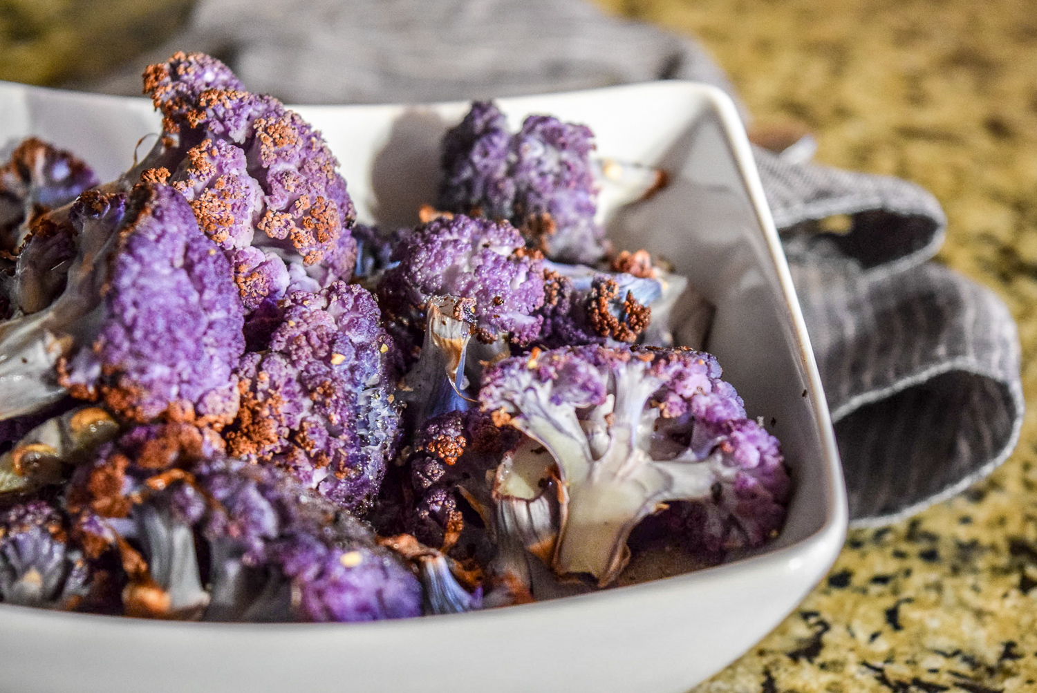 Finished roasted purple cauliflower florets up close