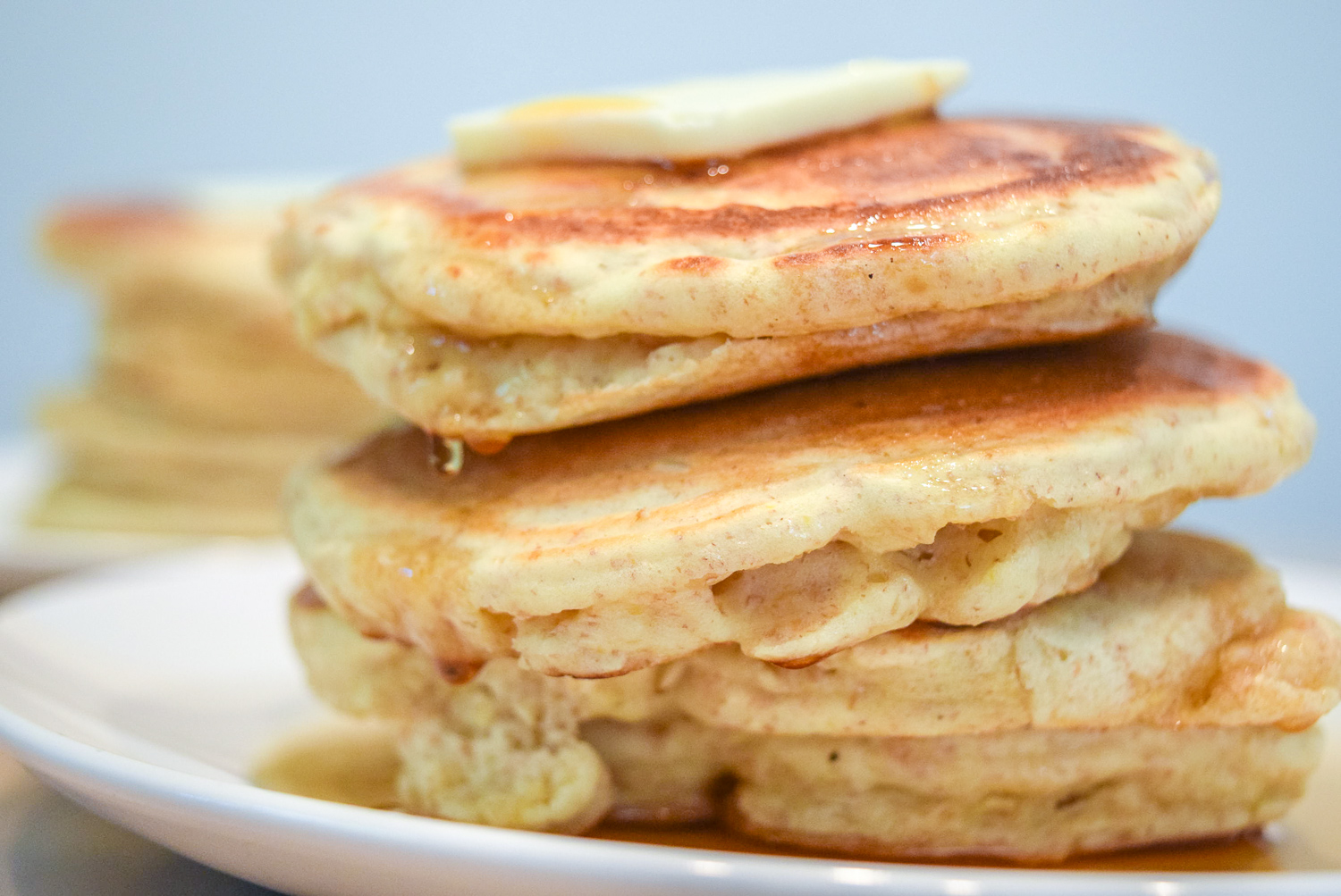 Trader Joe's Multigrain Pancake Mix stacks with butter and maple syrup up close