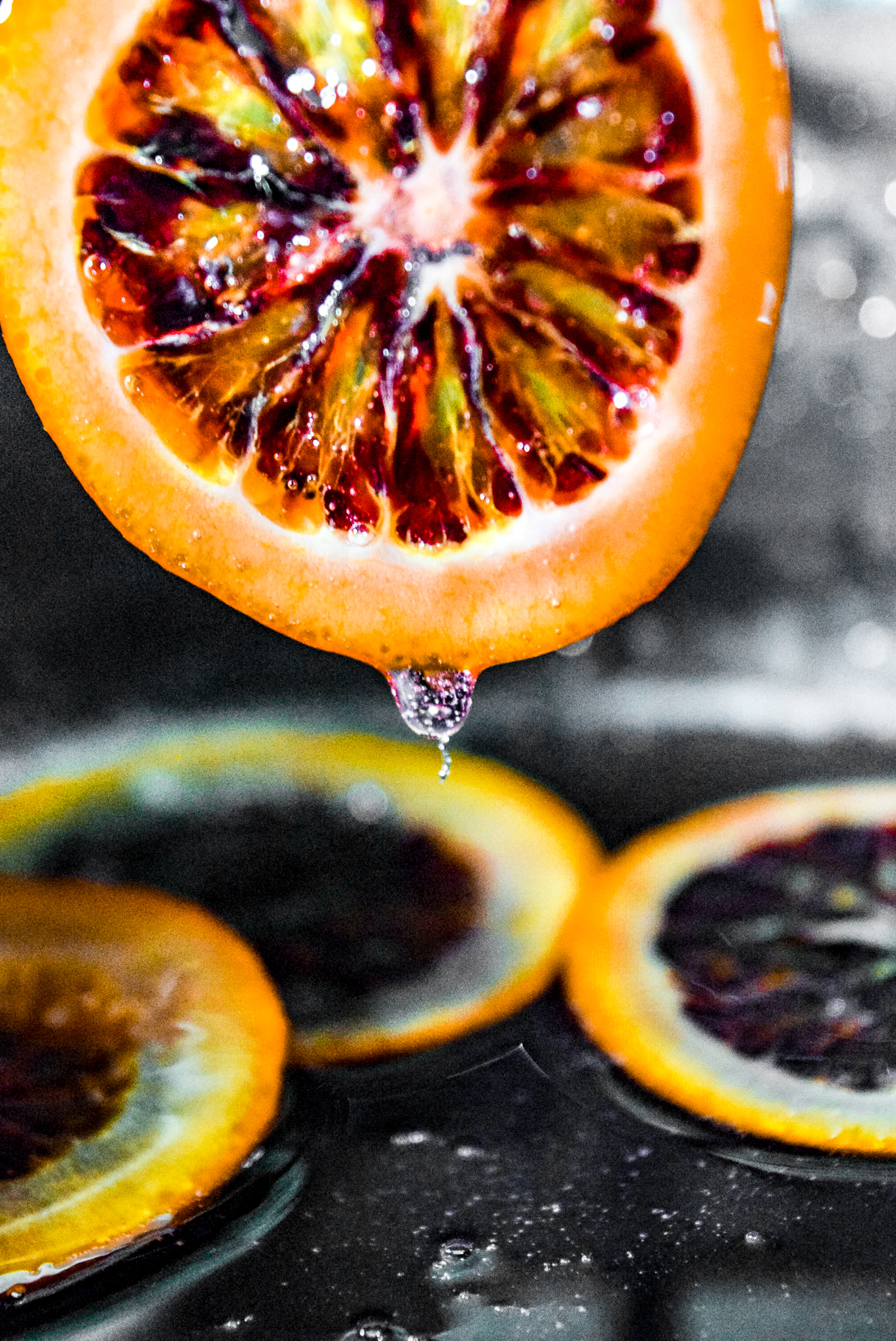 Removing blood orange slice from sugar water after candying