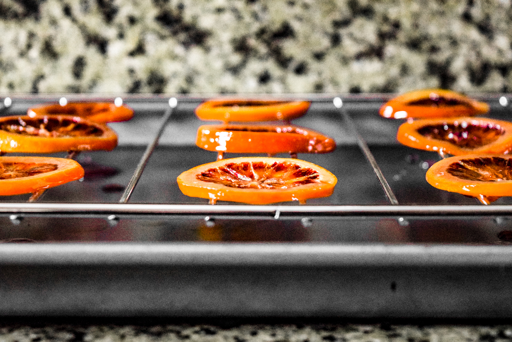 Two-Ingredient Candied Blood Orange Rounds drying and hardening after candying from front