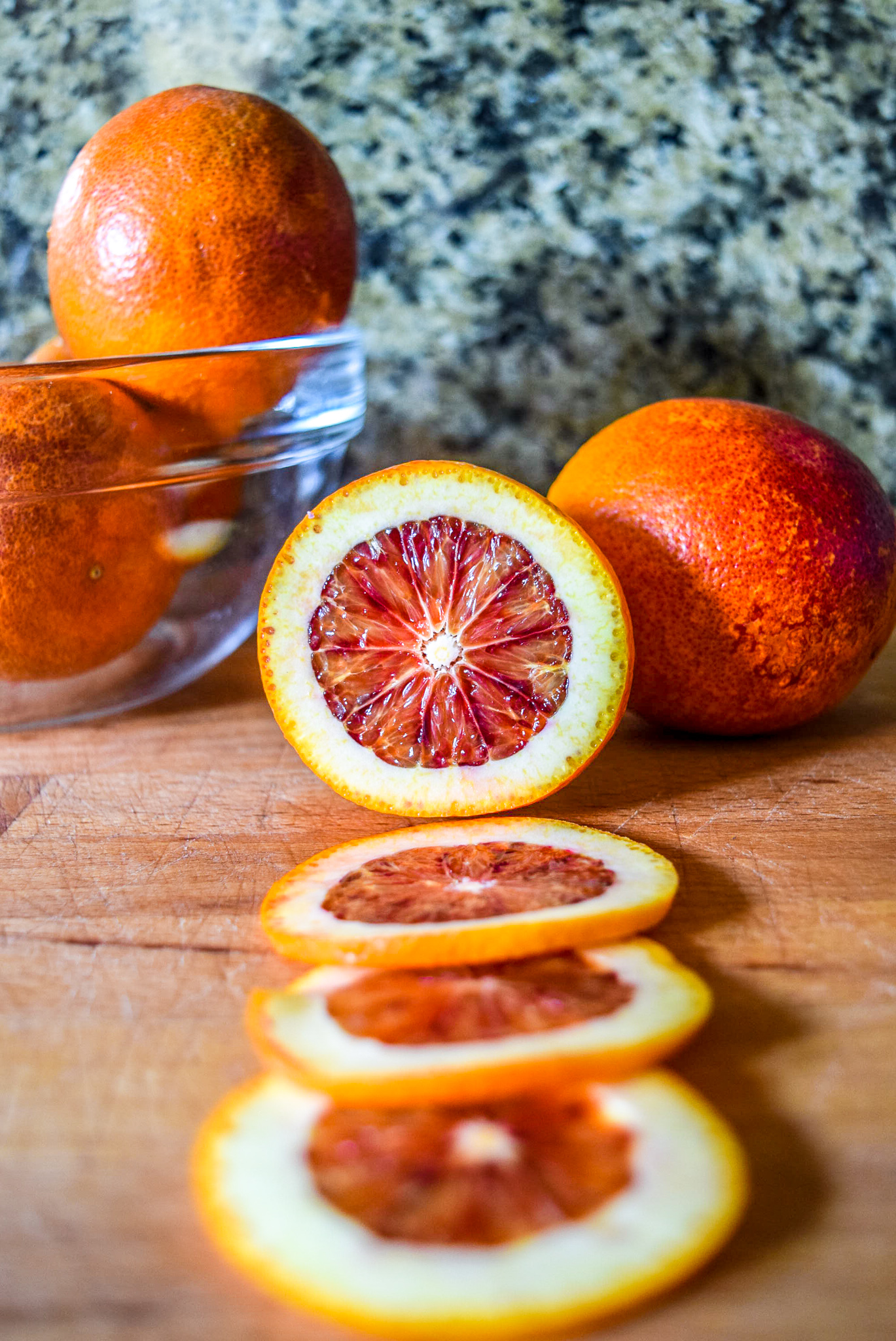 Sliced blood orange rounds in preparation for candying from front