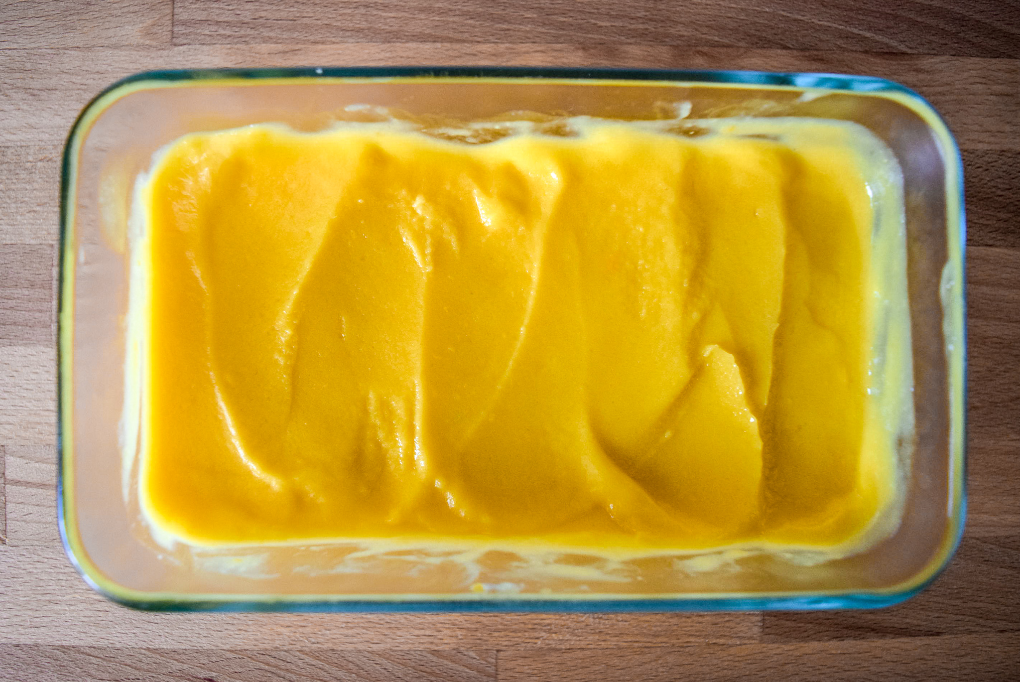 Two-Ingredient Almond Mango Ice Cream from top in pyrex container