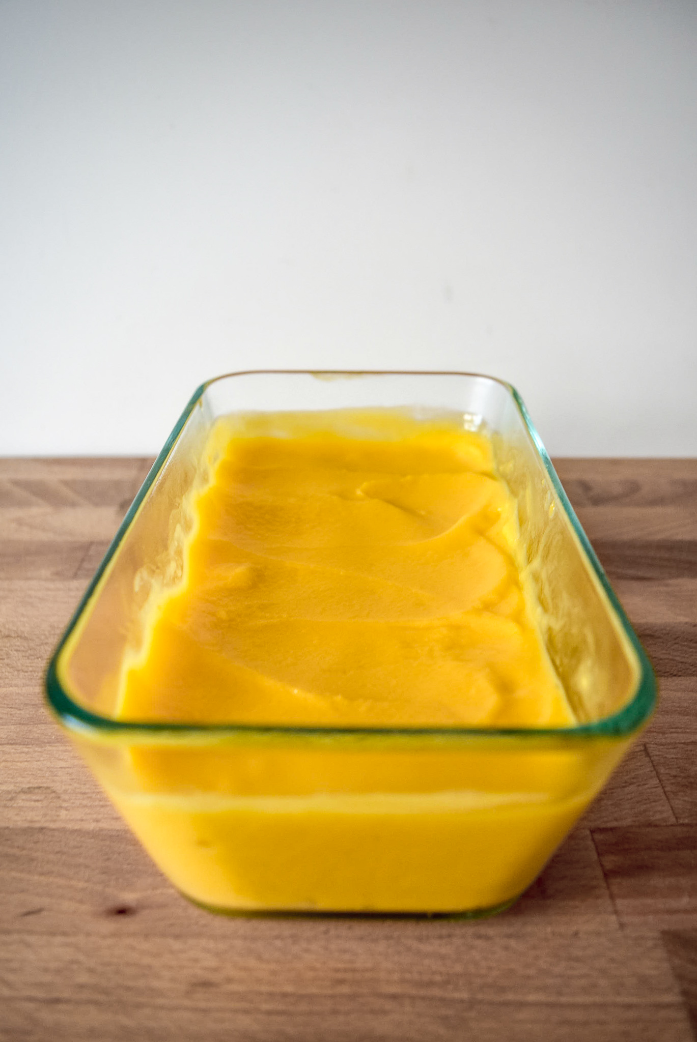 Two-Ingredient Almond Mango Ice Cream from front in pyrex container